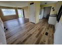 Inviting living room and kitchen featuring stylish flooring and a view of the front yard at 314 S Taft Ave, Indianapolis, IN 46241