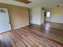 Spacious living room featuring stylish wood-look flooring and neutral walls at 314 S Taft Ave, Indianapolis, IN 46241