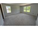 A bright, unfinished bedroom with two windows allowing for plenty of natural light at 3297 Godby Dr, Sheridan, IN 46069
