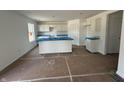 Spacious kitchen with white cabinets, center island, and abundant natural light, ready for customization at 3297 Godby Dr, Sheridan, IN 46069