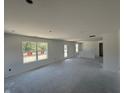 Spacious and bright unfinished living room featuring lots of natural light and high ceilings at 3297 Godby Dr, Sheridan, IN 46069