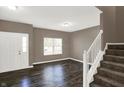 Inviting living room features hardwood floors, freshly painted walls, and bright window at 3529 Miesha Dr, Indianapolis, IN 46217