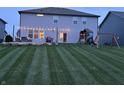 Beautiful backyard with lush lawn, play set, patio, and outdoor seating, perfect for Gathering fun and entertaining at 3650 Tipperlin Rd, Bargersville, IN 46106