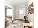Bright entryway featuring wood floors, a decorative rug, and a white front door at 3650 Tipperlin Rd, Bargersville, IN 46106