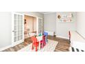 Another view of the playroom showcasing French doors and decor at 3650 Tipperlin Rd, Bargersville, IN 46106