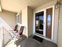 Welcoming front door with a glass insert and a covered porch with seating at 3730 Cheyenne Ct, Columbus, IN 47203