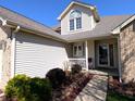 Inviting front porch featuring decorative landscaping and a cozy seating area at 3730 Cheyenne Ct, Columbus, IN 47203