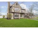 Elegant Tudor-style home featuring a combination of stone and half-timbered facade at 3892 Arrowhead Ct, Greenfield, IN 46140