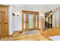 Inviting foyer with hardwood floors, a grand staircase, and a stylish front door at 3892 Arrowhead Ct, Greenfield, IN 46140
