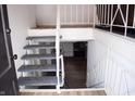 Stairway leading to the basement with painted stairs and metal railings at 4107 Eisenhower Dr, Indianapolis, IN 46254