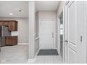 Inviting foyer with tiled flooring, leading to the kitchen and a carpeted bedroom at 4280 Zachary Ln, Westfield, IN 46062