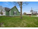 This home features a well-maintained lawn and mature tree providing plenty of shade at 501 S John St, Arcadia, IN 46030