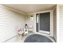 Cozy front porch with charming seating area, decorative lantern, and an attractive rug at 5856 Long Ridge Pl, Indianapolis, IN 46221