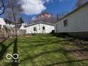 Spacious backyard featuring a well-manicured lawn and wooden fence for privacy at 5868 Hillside Ave, Indianapolis, IN 46220