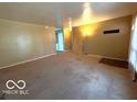 Spacious living room with neutral carpet and view of an adjacent room at 5868 Hillside Ave, Indianapolis, IN 46220