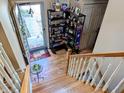 View of entryway with hardwood stairs and landing with display shelf and coat closet at 61 Osage Ct, Columbus, IN 47201