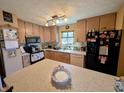 Functional kitchen featuring light wood cabinets and a large island for food preparation at 61 Osage Ct, Columbus, IN 47201