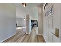 Inviting entryway showcasing hardwood floors, modern lighting, and a glimpse into the open-concept kitchen and living area at 6508 Pergola Ln, Indianapolis, IN 46241