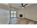 Cozy living room with fireplace, hardwood floors, and sliding glass doors leading to the outdoor deck, perfect for relaxation at 6508 Pergola Ln, Indianapolis, IN 46241