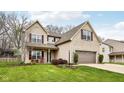Well-maintained home with a two-car garage, complemented by lush landscaping at 6526 Angel Falls Dr, Noblesville, IN 46062