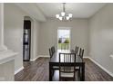Dining room featuring a dark wood table with seating for six and modern chandelier lighting at 6674 Buhrstone Ln, Avon, IN 46123