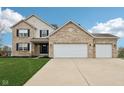 Beautiful exterior of a brick and siding home featuring a three-car garage at 6707 Meadow View Ct, Avon, IN 46123