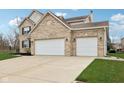 Spacious three-car garage with ample driveway space on this beautiful home's exterior at 6707 Meadow View Ct, Avon, IN 46123