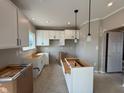 Bright, white kitchen featuring cabinetry, pendant lighting, and an island, not yet completed at 7308 Broadview Ln, McCordsville, IN 46055