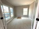Room features a wall of windows, light-colored walls, and an unfinished floor at 7308 Broadview Ln, McCordsville, IN 46055