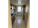 Galley kitchen features white appliances and neutral colored cabinetry at 7411 Country Brook Dr, Indianapolis, IN 46260