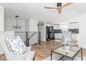 Open-concept living space with hardwood floors and seamlessly connected to the modern kitchen at 7624 Snowflake Dr, Indianapolis, IN 46227