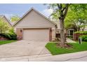 Charming home featuring brick and siding, complemented by a well-maintained lawn and attached two-car garage at 8535 Olde Mill Circle West Dr, Indianapolis, IN 46260