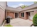 Private patio with awning, perfect for outdoor grilling, with brick exterior and sliding glass door access at 8535 Olde Mill Circle West Dr, Indianapolis, IN 46260
