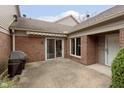 The patio offers an outdoor space with brick walls, a sliding glass door, and a gas grill at 8535 Olde Mill Circle West Dr, Indianapolis, IN 46260