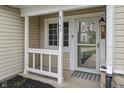 Close-up of the home's welcoming front porch, with a view of the front door and address at 8747 Knotty Pine Ct, Indianapolis, IN 46227
