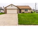 Lovely home boasts a two-car attached garage and well maintained lawn at 8973 Sunningdale Blvd, Indianapolis, IN 46234