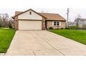 Delightful home features an attached two-car garage and concrete driveway at 8973 Sunningdale Blvd, Indianapolis, IN 46234