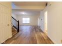 Bright entryway featuring wood floors, a staircase, and access to multiple rooms, creating an inviting atmosphere at 904 Adena Ln, Westfield, IN 46074