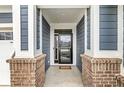 Inviting entryway with brick columns, a dark front door with glass, and a view to the outside at 9925 Glendon Ct, McCordsville, IN 46055