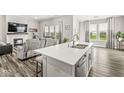 Open floor plan kitchen with white countertops, stainless steel appliances, and an island with a sink at 9925 Glendon Ct, McCordsville, IN 46055