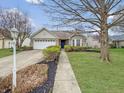 Charming single-story home with well-maintained landscaping and a two-car garage at 10200 Cheswick Ln, Fishers, IN 46037