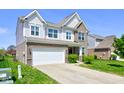 Inviting two-story home showcasing a two-car garage and manicured front yard at 10602 Pintail Ln, Indianapolis, IN 46239