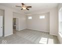 Spacious primary bedroom with plush carpet flooring, windows, and ensuite bathroom at 13316 E Lieder Way, Fishers, IN 46037