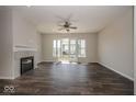 Bright living room featuring hardwood floors, a fireplace, and a sliding glass door at 13316 E Lieder Way, Fishers, IN 46037