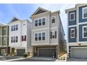 Modern three-story townhome with a garage and ample windows at 13316 E Lieder Way, Fishers, IN 46037