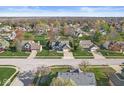 An aerial view of a peaceful neighborhood with mature trees and well-maintained lawns at 1417 Macintosh Ct, Avon, IN 46123