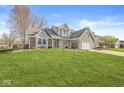 Charming two-story home with brick accents and a well-manicured lawn at 1417 Macintosh Ct, Avon, IN 46123