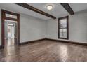 Bright living room boasting hardwood floors, detailed trim, and an open layout for versatile living at 143 W Washington St, Mooresville, IN 46158