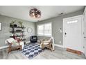 Bright living room featuring a decorative ceiling fan, wood-look floors, and a cozy seating area at 1508 Douglas Dr, Franklin, IN 46131