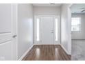 Inviting home foyer with wood-look flooring and a bright white front door with sidelights at 1616 Capra Ct, Beech Grove, IN 46107